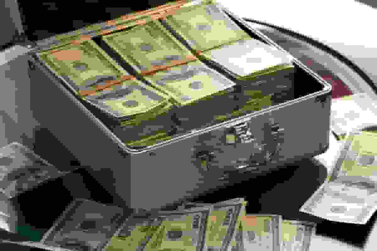 Cash securely stored in an open lockbox, symbolizing business financial protection and security